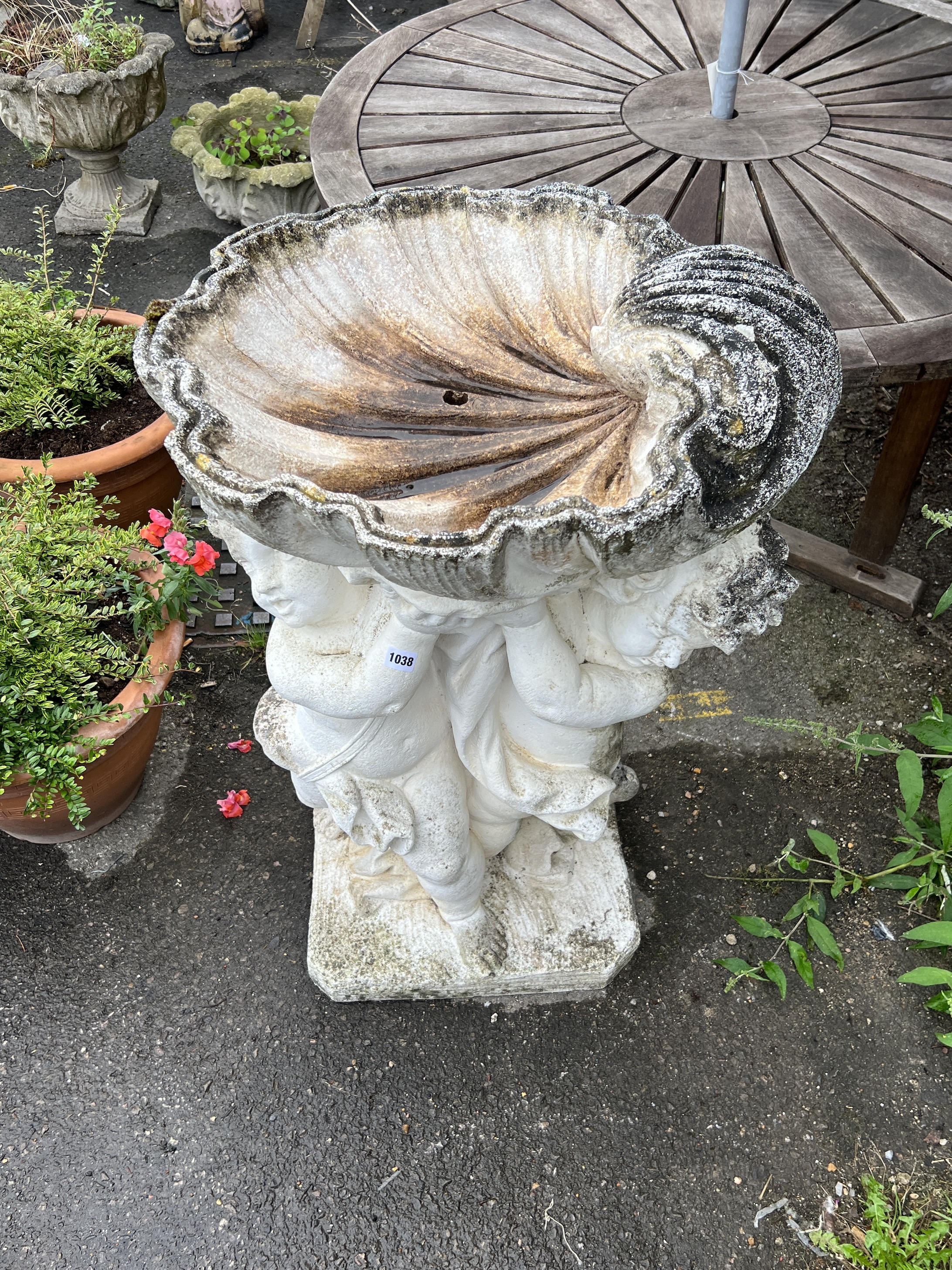 A large painted stone cherub and scallop shell garden fountain, height 93cm